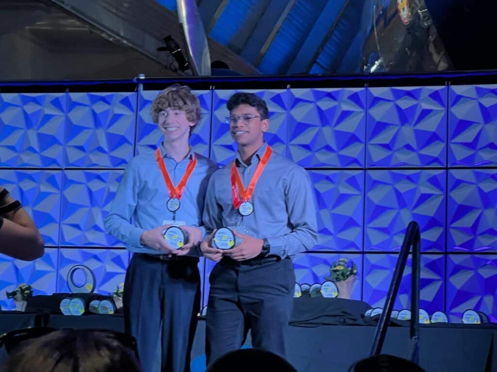 Susskind and Kumar accept their awards on stage during the awards ceremony