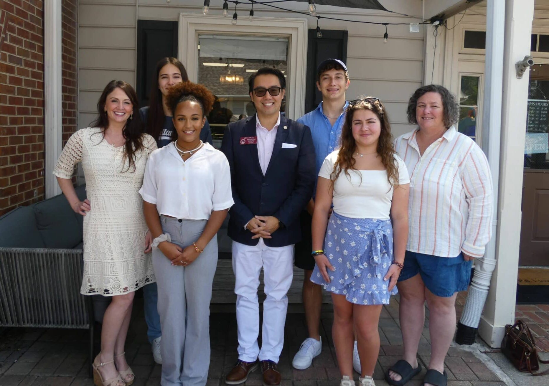 The four exchange students and their coordinators with Long Tranoutside of Peachy Corners Café