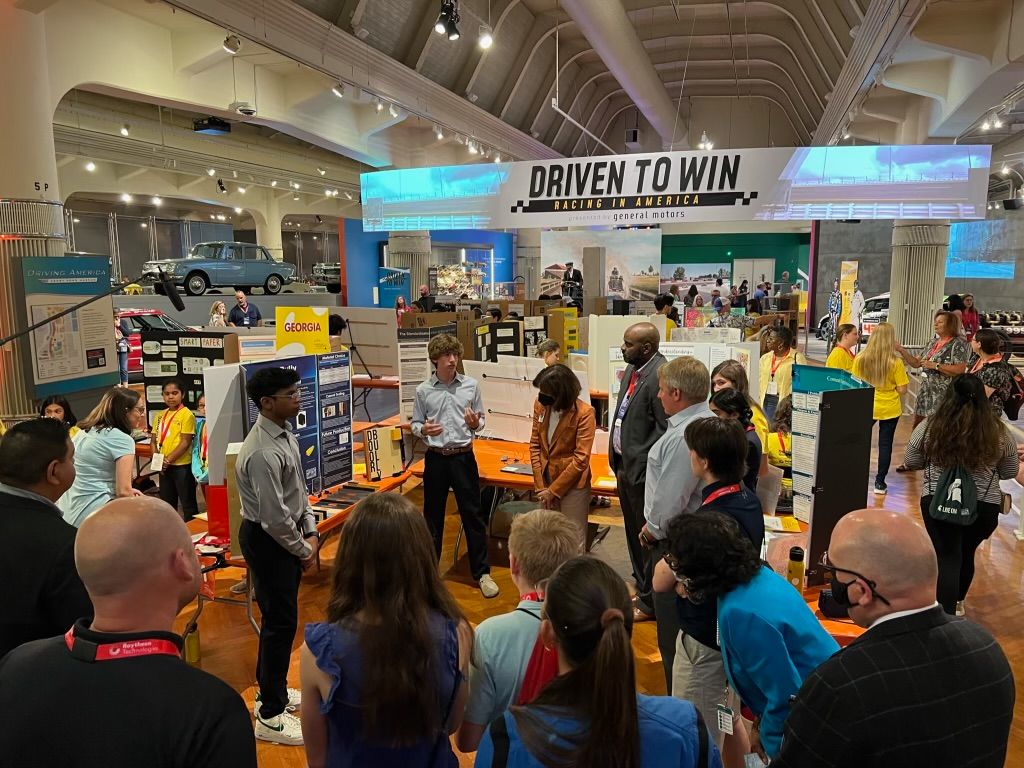 Kumar and Susskind give a presentation about their invention at the Henry Ford Museum.