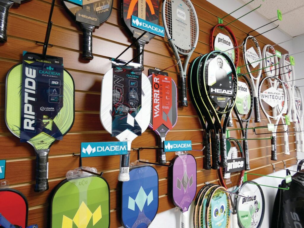 Some of the many pickleball paddles and tennis rackets offered in
store