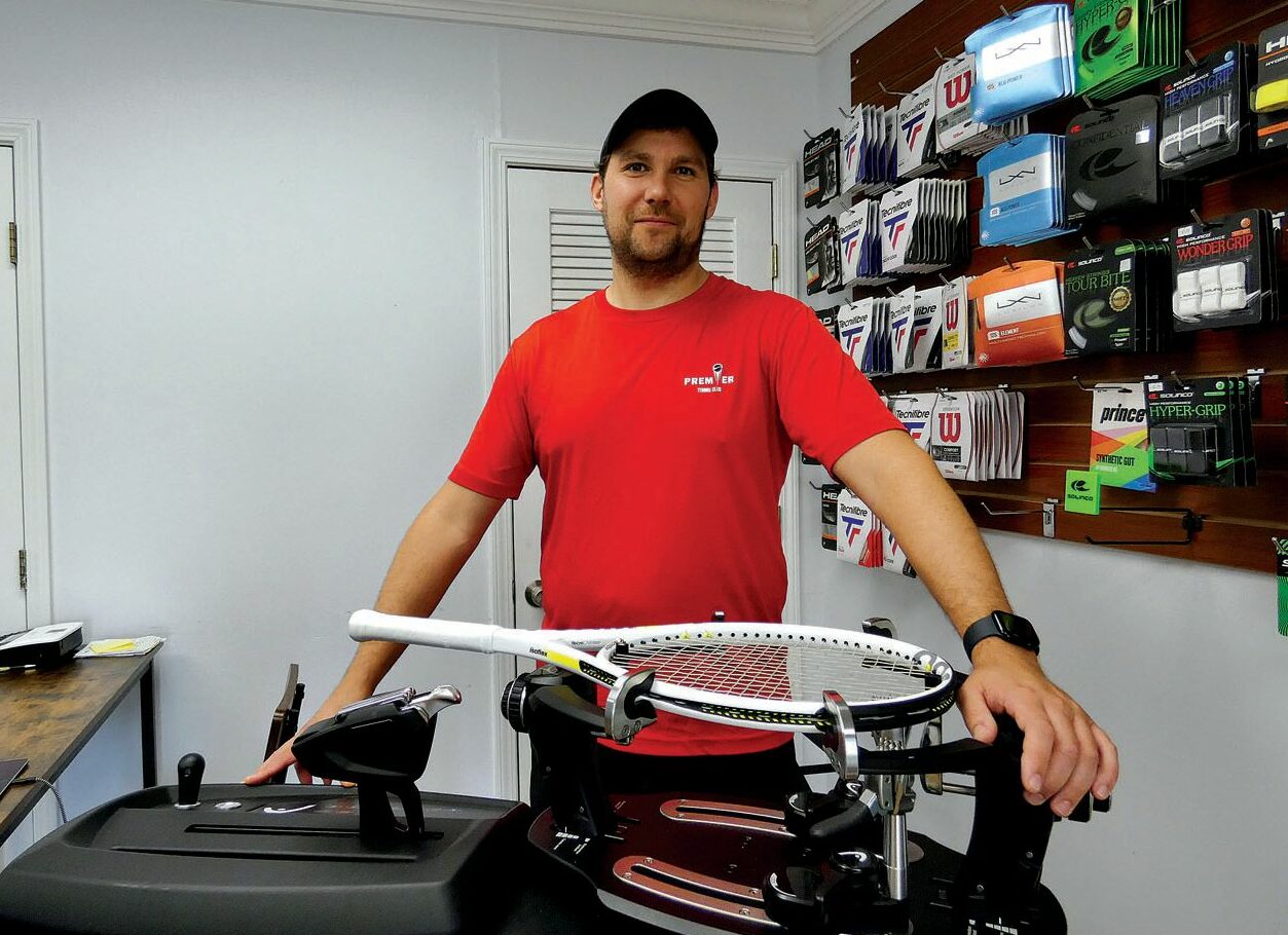 Claude Badowski behind a racket stringer