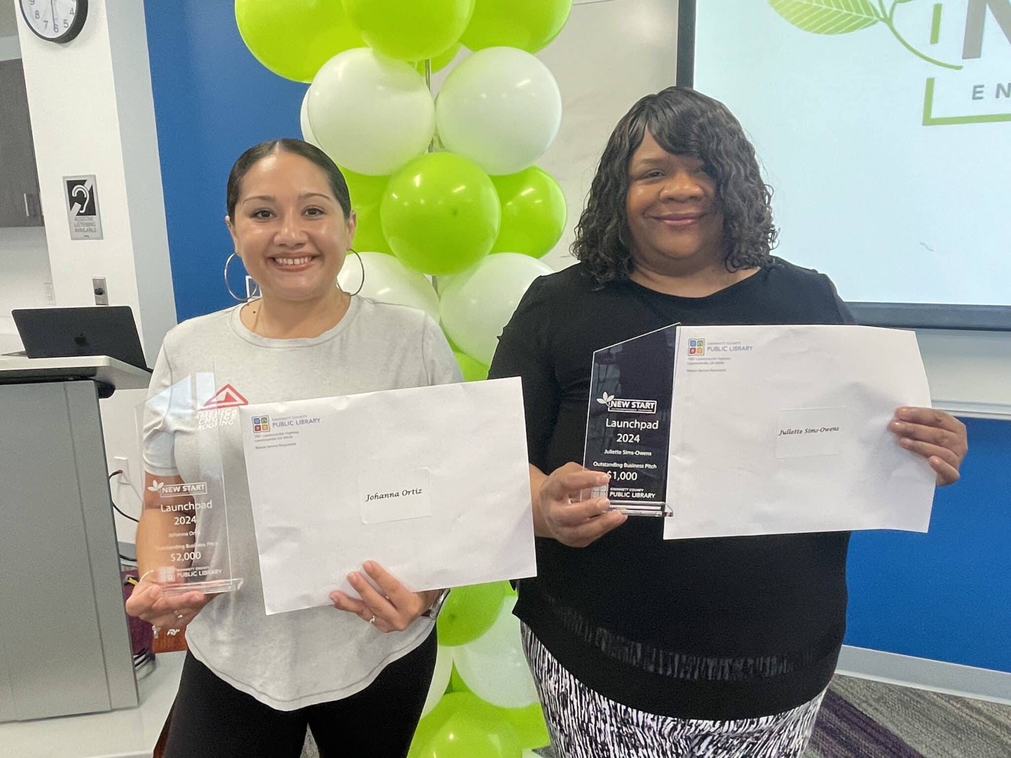 Two women receiving entrepreneurship awards