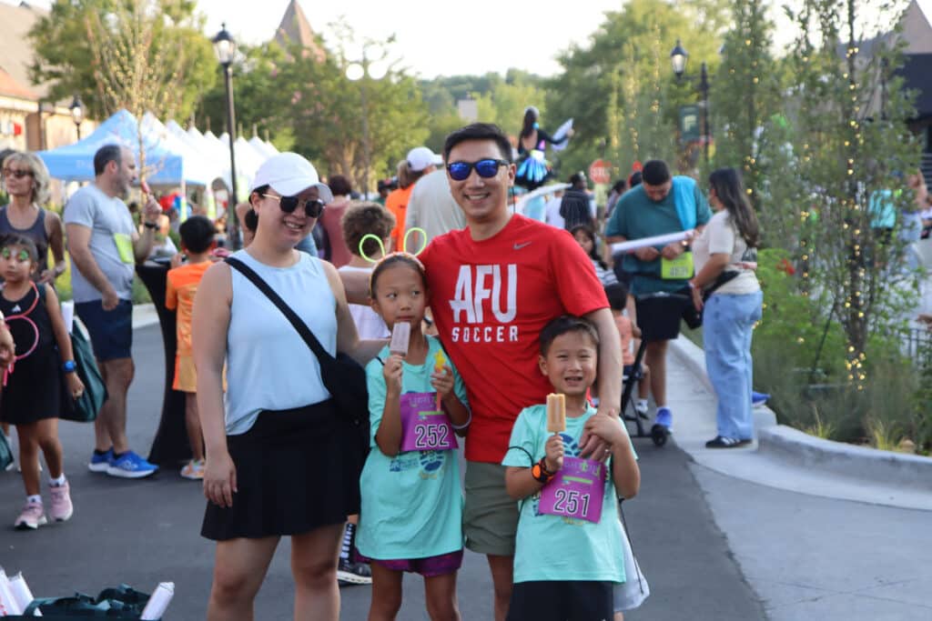 Smiling family of four at an outdoor festival