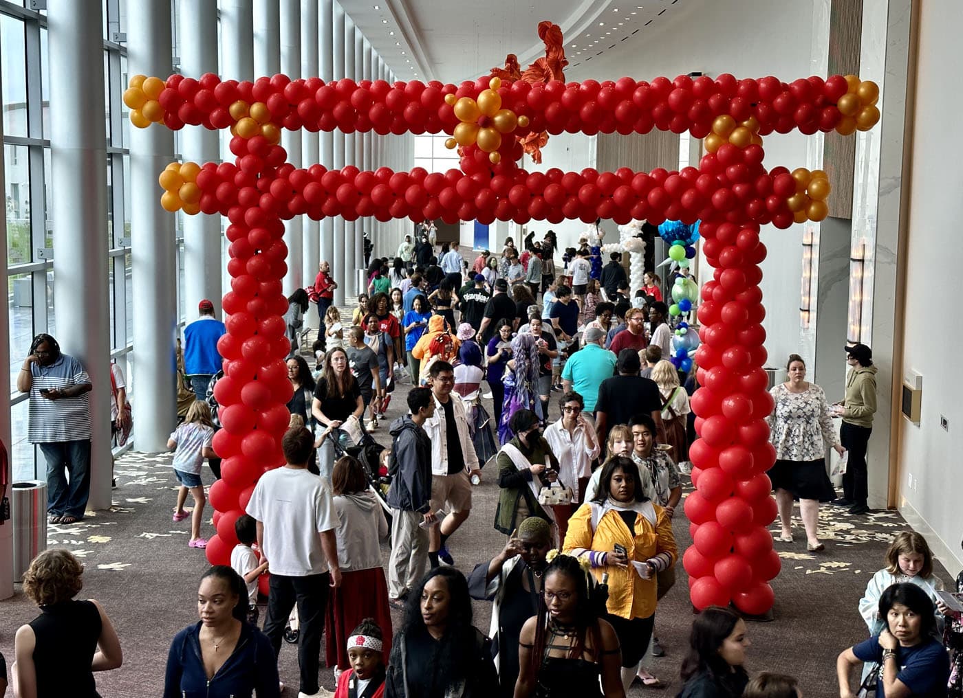 crowd of people walking through a large red arch at JapanFest