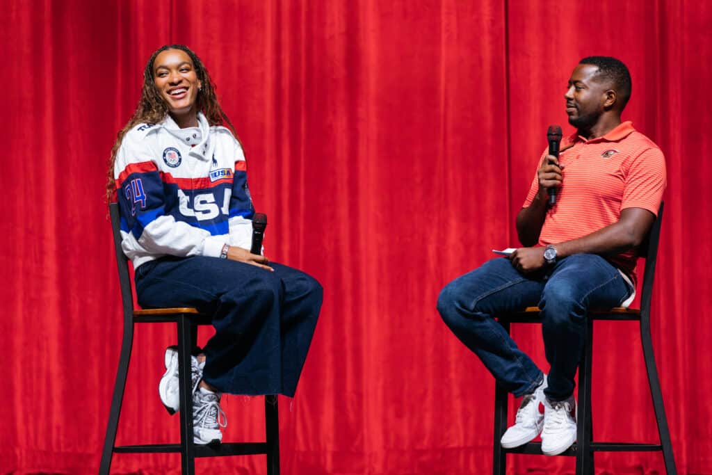 Female Olympic athlete being interviewed onstage