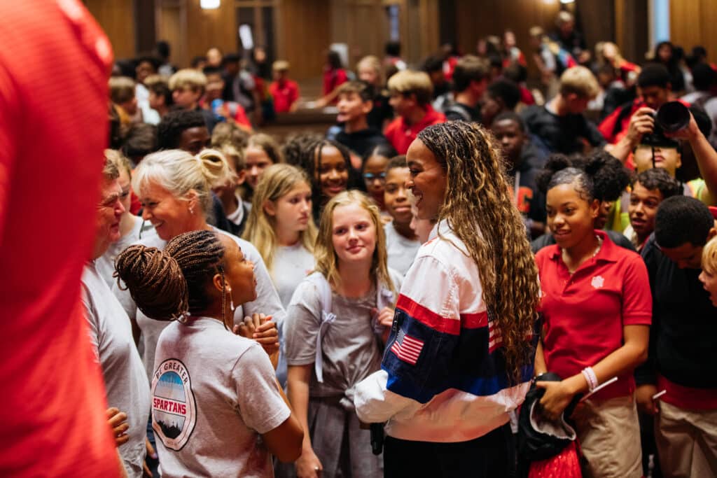 Female Olympian meeting students at her alma mater