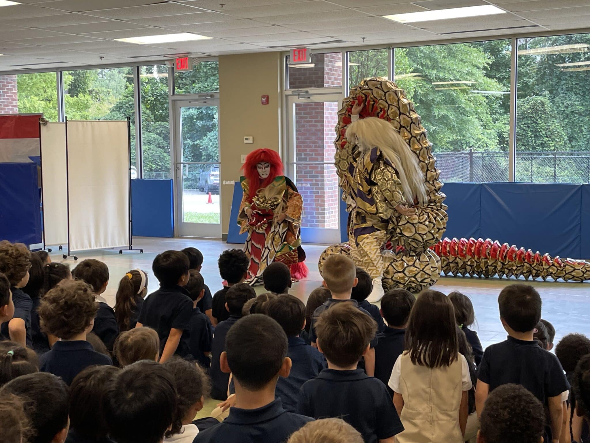 kabuki performers in front of an audience of K-6 students