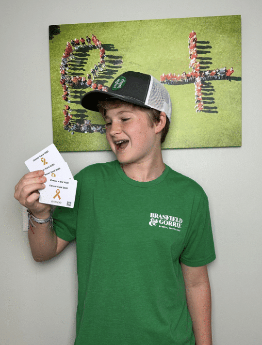 Teen boy smiling and holding discount fundraising cards