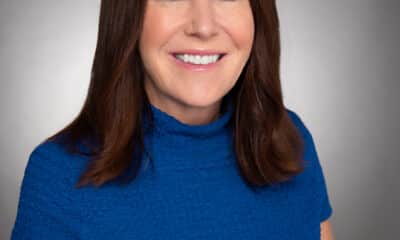 Professional headshot of a brown-haired woman wearing a blue top