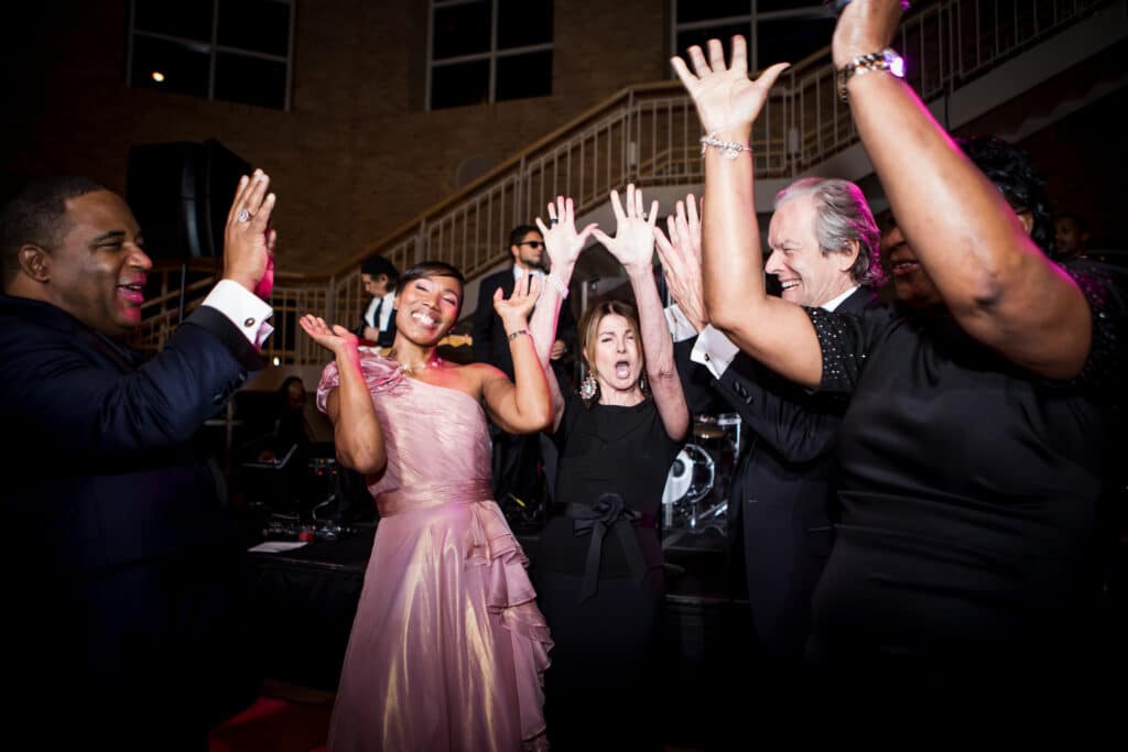 Smiling people dancing together at a fundraising gala