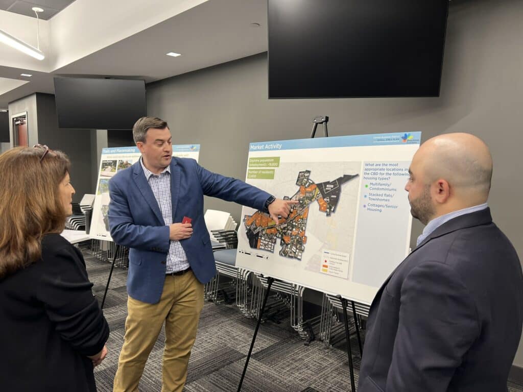 People looking at a map display at a city meeting