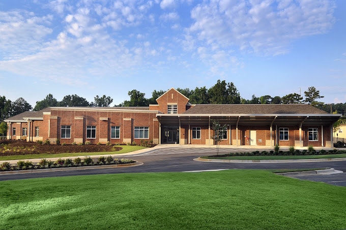 a school building and green lawn