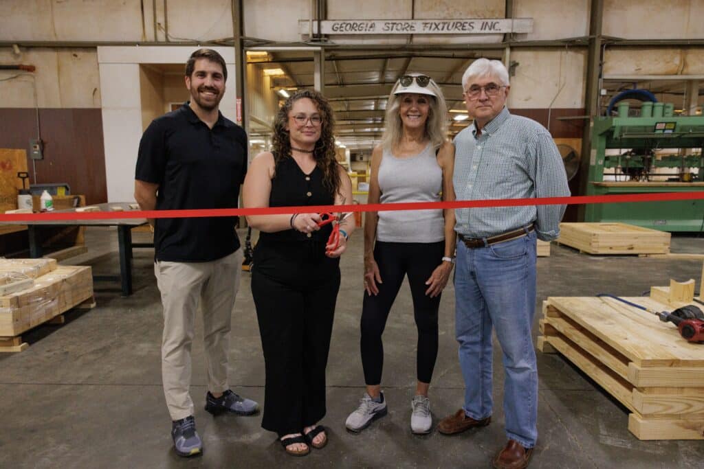 four people at a ribbon cutting as TransPak acquires Reid Packaging