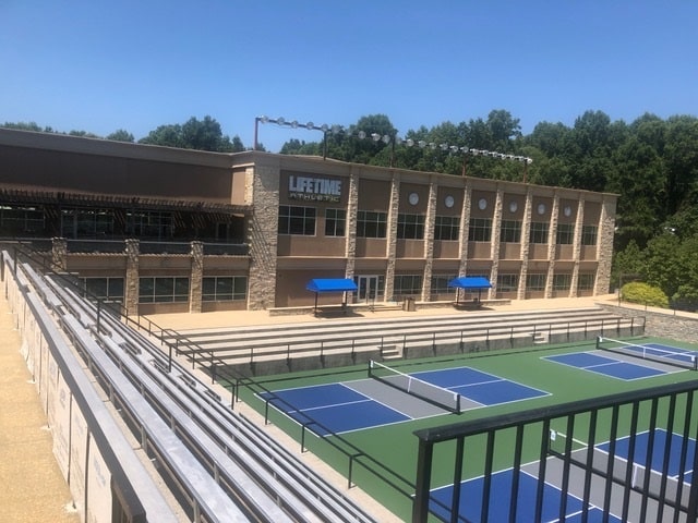 large outdoor facility with tennis and pickleball courts