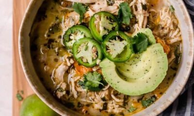 bowl of white chicken chili topped with jalapenos and avocado