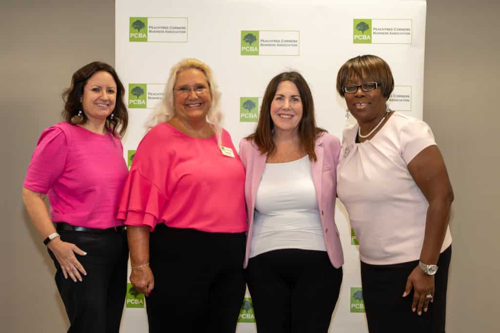 Four women at a PCBA meeting