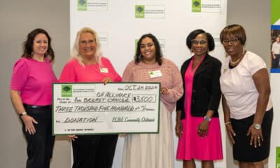 Group of women holding a large check representing a donation from PCBA to GABC