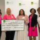 Group of women holding a large check representing a donation from PCBA to GABC