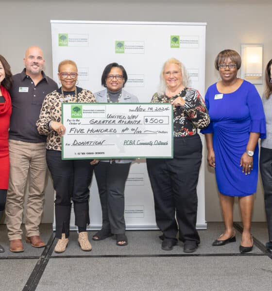 Members of the PCBA and United Way of Greater Atlanta standing together holding an oversized donation check for $500