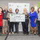 Members of the PCBA and United Way of Greater Atlanta standing together holding an oversized donation check for $500