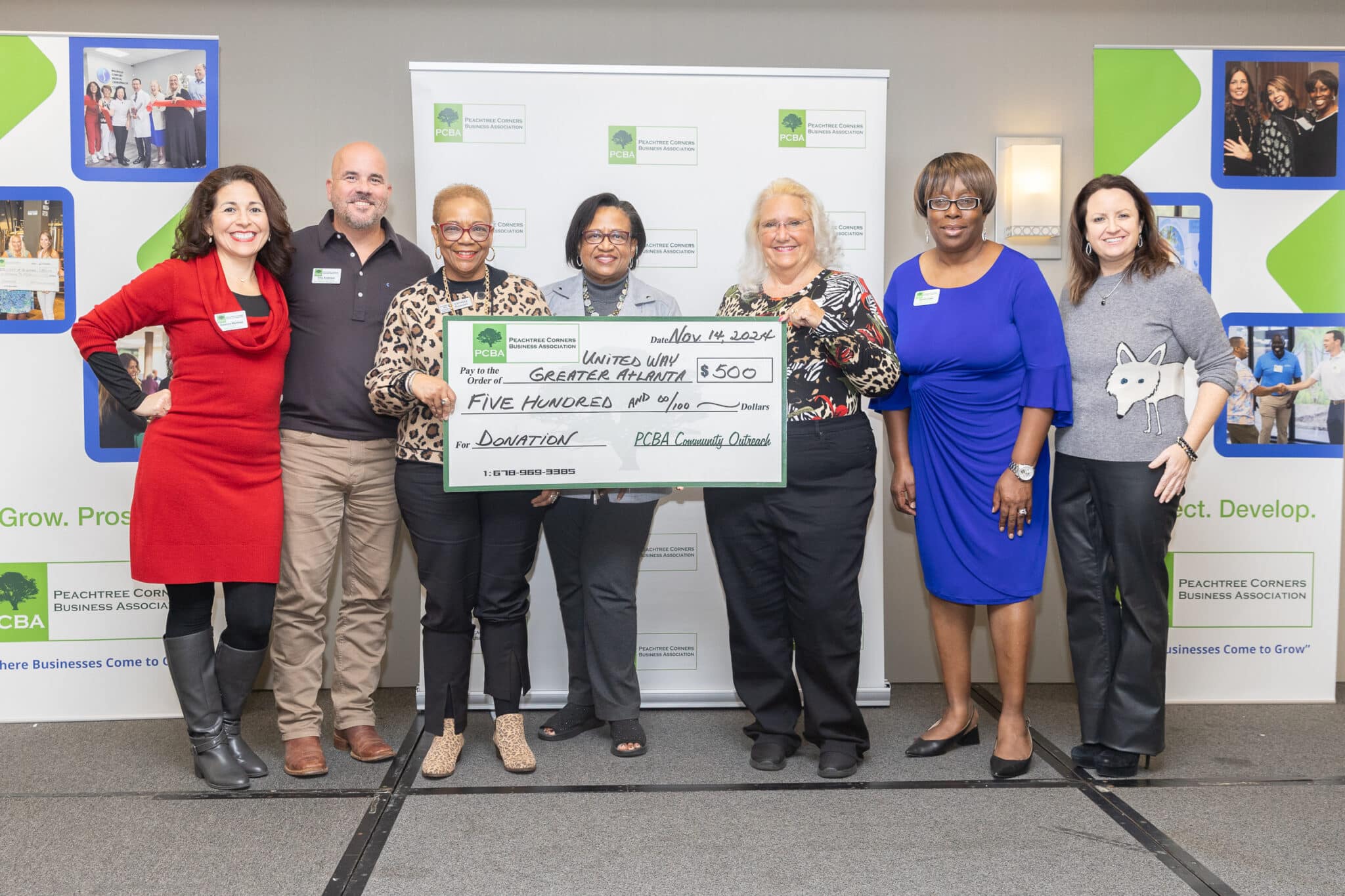 Members of the PCBA and United Way of Greater Atlanta standing together holding an oversized donation check for $500