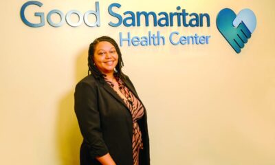 Professional woman standing in front of Good Samaritan Health Center signage