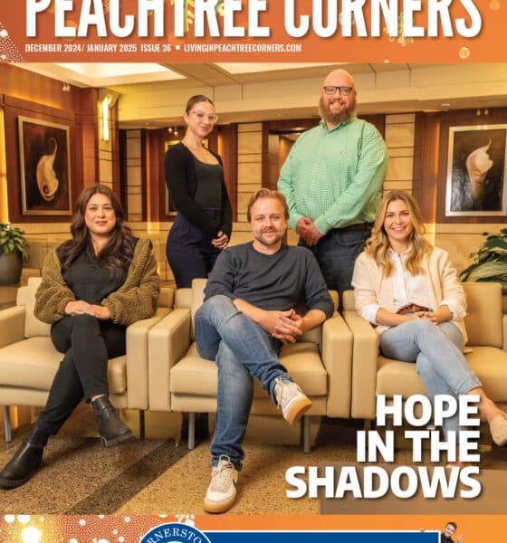 Peachtree Corners Magazine cover featuring a team of attorneys, casually dressed, in the law firm's reception area.