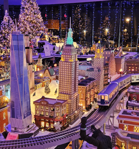 Detailed model train village display, lit up for the holidays