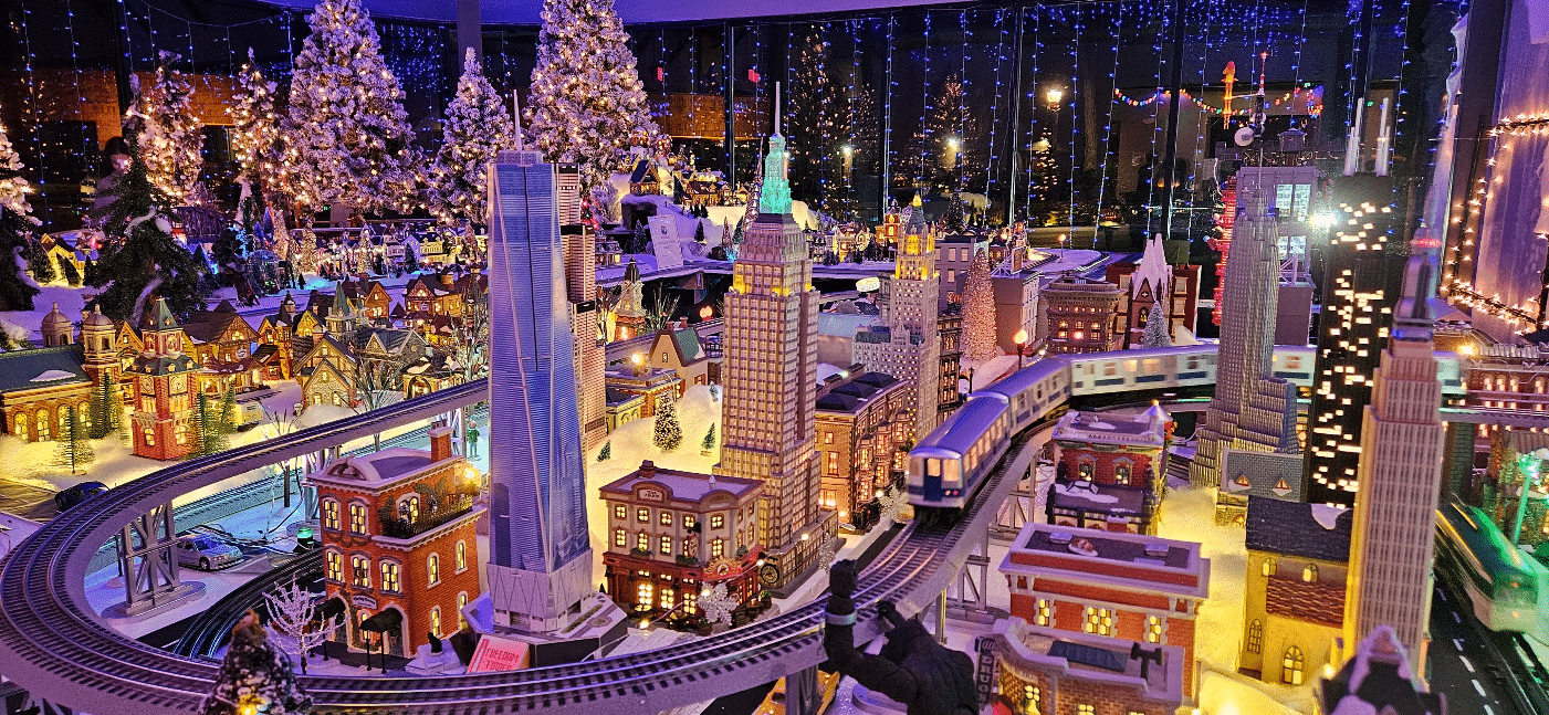 Detailed model train village display, lit up for the holidays