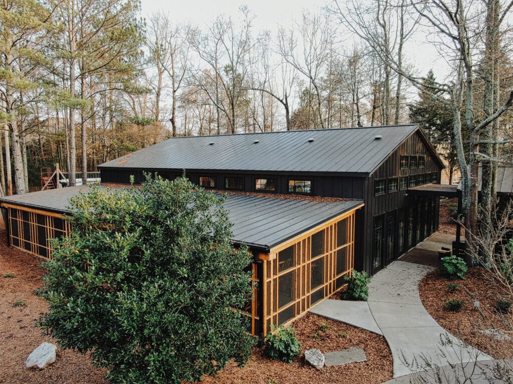 Two-story event center surrounded by a wooded landscape 