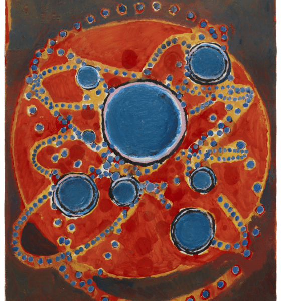 Oil on paper artwork by Terry Winters. A large red circle with smaller blue circles on top of it and gold/yellow accents. All of it on a dark brown background.