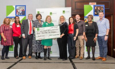 A group of people holding a large check to represent a $3500 donation from the PCBA to the Spectrum Autism Support Group