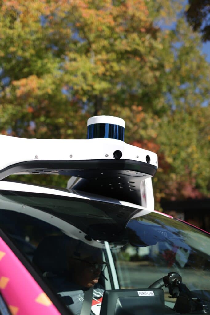 Up-close look at the rooftop sensor on the multi-colored, self-driving car from May Mobility on the road in Peachtree Corners