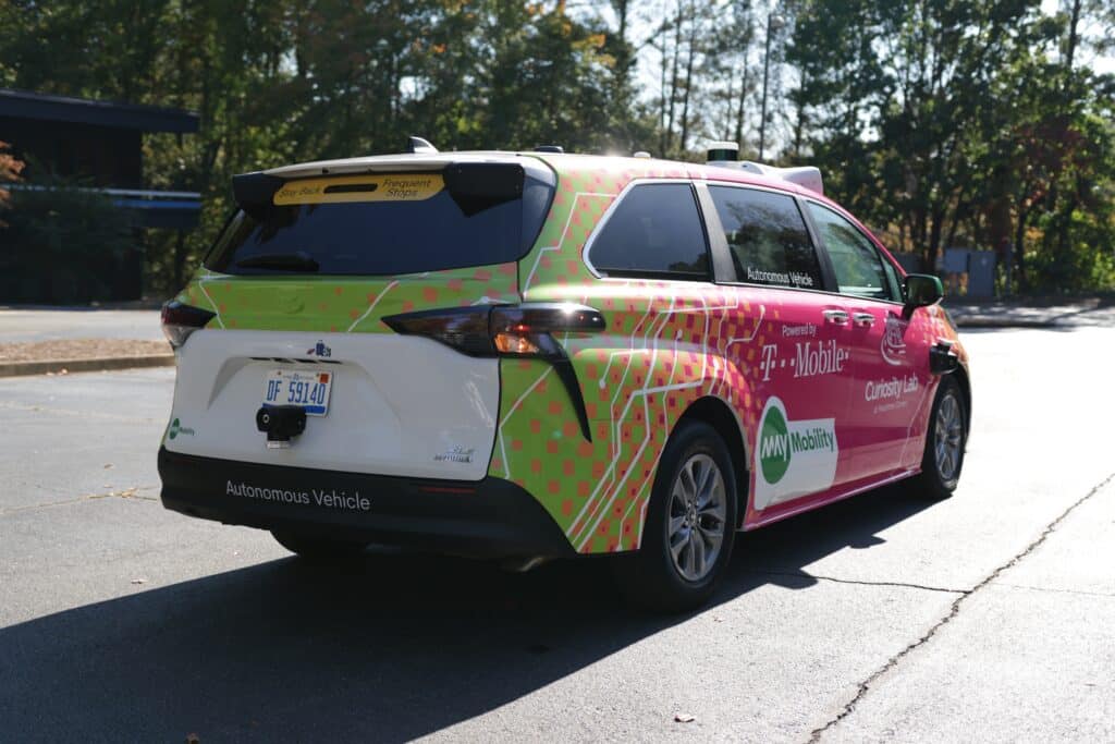 Rear view of multi-colored, self-driving car from May Mobility on the road in Peachtree Corners