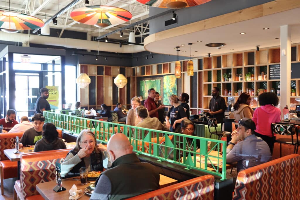 People sitting at booths and tables having lunch at Nando's PERi-PERi in Peachtree Corners.