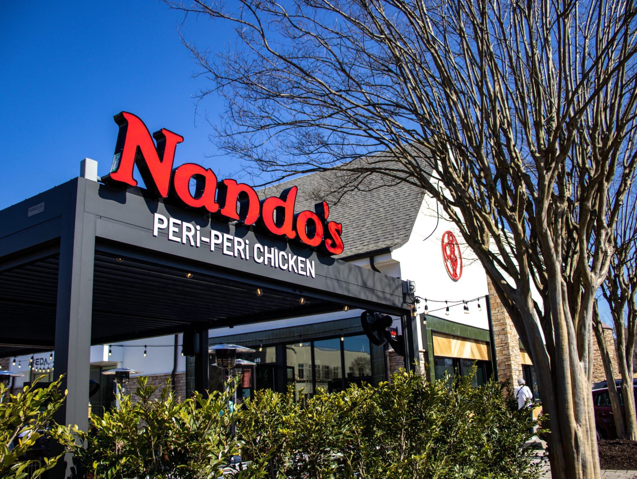 Exterior signage and covered patio at Nando's PERi-PERi in Peachtree Corners