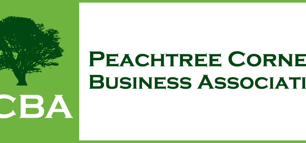 Peachtree Corners Business Association log with dark green tree on a light green background and PCBA in white type.