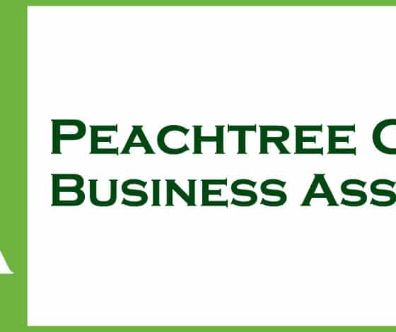 Peachtree Corners Business Association log with dark green tree on a light green background and PCBA in white type.