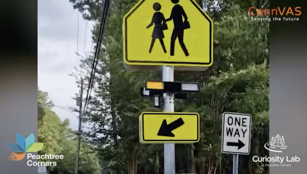 Pedestrian crossing sign with lights in a suburban neighborhood