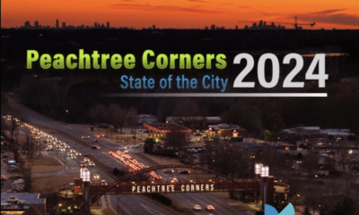 Aerial view of Peachtree Corners at night as the sun sets. Peachtree Corners State of the City 2024 in green, blue and white text is laid over the image and the PTC logo is in the bottom right corner.