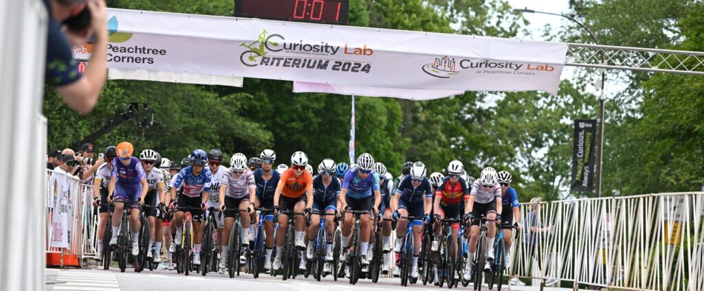 A group of bikers at the starting line, competing in a bike race. 