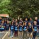 Group of children and adults wearing dark blue tshirts at an outdoor Children's Day festival in Norcross, Georgia