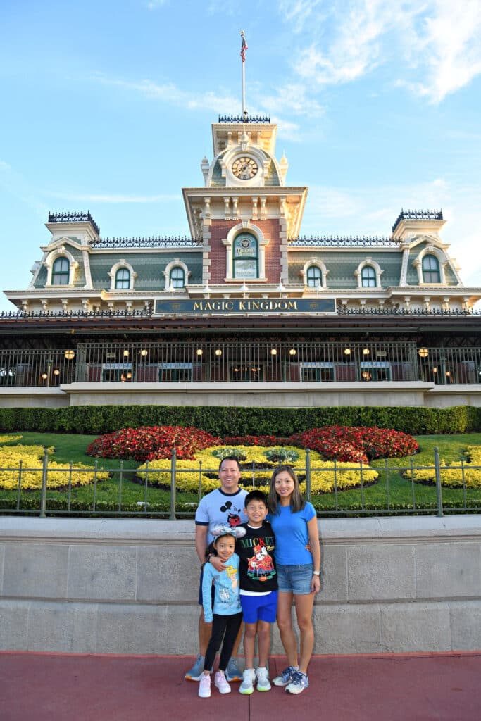 An Asian-American family with a mom and dad and two young children (a boy and a girl) at Disney World.