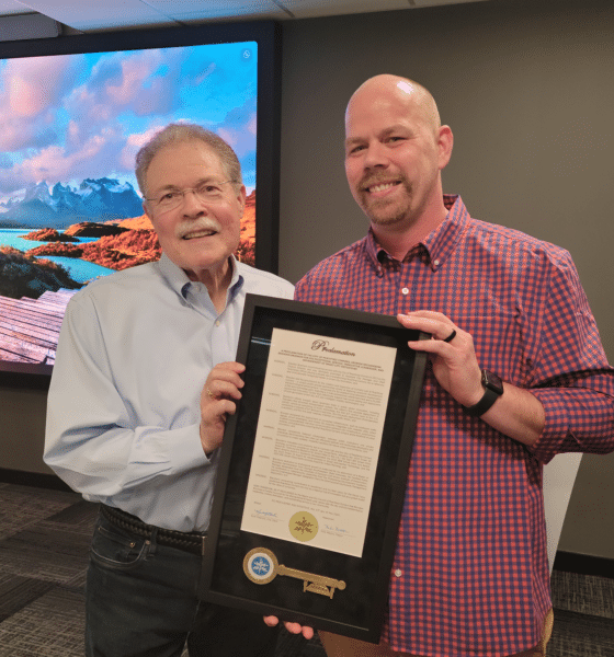 Mayor Mike Mason of Peachtree Corners presenting a proclamation for service to Assistant City Manager Brandon Branham