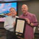 Mayor Mike Mason of Peachtree Corners presenting a proclamation for service to Assistant City Manager Brandon Branham