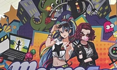 MomoCon 2025 entrance with colorful anime-style illustration and logo