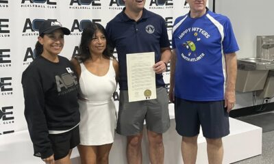 GA State Rep. Scott Hilton stands with two coaches and the manager of a Special Olympics of Georgia pickleball team, awarding House Resolution 700 commending them for their work.