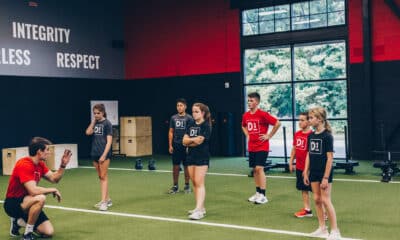 Young male and female teen athletes at an indoor fitness facility.