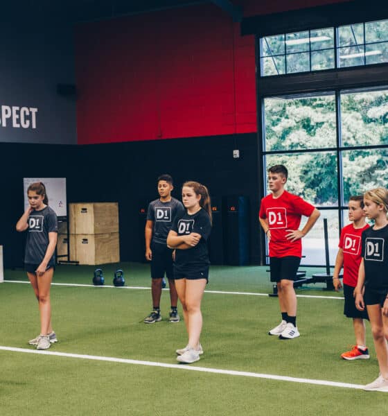 Young male and female teen athletes at an indoor fitness facility.