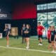 Young male and female teen athletes at an indoor fitness facility.